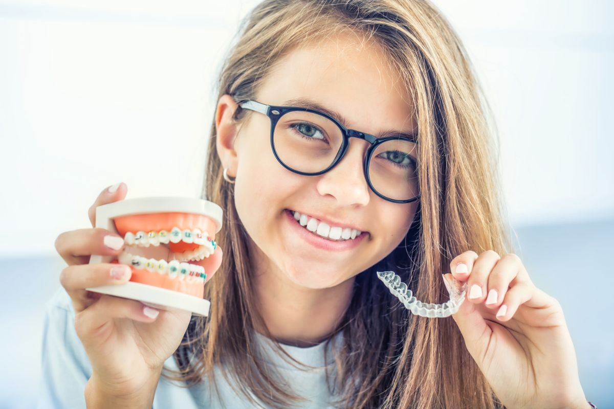 When it comes to straightening your smile, there are many different braces options. In the not-so-distant past, your options were pretty limited to big, cumbersome metal braces, but we&rsquo;re proud to say a lot has changed over the years. While metal braces are still the most reliable and efficient option, they have become a worthy contender even when compared to the more modern options like ceramic braces and clear aligners like Invisalign. Choosing between the many types of braces is just as important of an investment decision as deciding where to go for a family vacation. Okay, maybe vacation is usually more fun than braces, but your best smile investment is worth the results and will last a lifetime. With the many advanced options available, you can likely plan your new smile and your next vacation without sacrificing your budget or lifestyle. Dr. Ryan Wiesemann and his skilled team at Wiesemann Orthodontics are committed to providing high-quality orthodontic treatment options that fit your needs, lifestyle, and budget for patients all around Bowling Green and Russellville, Kentucky, and Portland and White House, Tennessee. Dr. Wiesemann believes your smile should be done right, and he works hard to ensure each person loves their smile. Let&rsquo;s go over the different types of braces we specialize in here at Wiesemann Orthodontics. That will ensure you&rsquo;re prepared for your first visit on your journey to your new smile! Braces Basics In any discussion about orthodontic treatment, you should consider the difference between your fixed and removable options. At one time, all braces were fixed braces. They adhered to your teeth, and that was the end of the structural design, much less the options for appearances or aesthetics. Now, not only have your fixed braces options expanded, but you also have removable braces options that can give you an efficient treatment while meeting your style and easing your hygiene routine during the process. It&rsquo;s like you can have your cake and eat it, too; just remember to floss and brush well afterward. Fixed Orthodontic Appliances Fixed braces are orthodontic appliances that are applied directly to your teeth and can only be removed by your orthodontist at the end of your treatment. There is no denying the power that comes from a direct bond in manipulating the movements of your teeth, gums, and even jaw. When it is proven the most efficient way to straighten your smile, the only thing that can be done to improve the process is to make it more comfortable and visually pleasing, or at least less visibly noticeable. That&rsquo;s just what has happened with traditional metal braces. They aren&rsquo;t so conventional anymore. The old bulky brackets have been replaced with smaller, lighter, and sleeker brackets made of high-quality metal or ceramic materials. The archwire is even thinner while being stronger. For our Wiesemann Orthodontics patients, we offer a huge selection of colorful elastic bands that we utilize for a fun spin on our ligatures. Some versions of metal braces, called self-ligating braces, eliminate the ligatures that secure the archwire to the brackets by using a bracket that includes a clip mechanism. This clip allows the bracket to slide along the archwire comfortably while maintaining adequate pressure to keep your treatment plan on track. Another modern fixed orthodontic appliance that has come about more recently is an option called lingual braces. Lingual braces still utilize the direct bond of brackets to your teeth, but instead of placing the brackets on the front side of your teeth, this method places the brackets on the back side of your teeth. In order for this option to be efficient, a special archwire must be utilized. Many patients find that while this is an aesthetic option, it does take a bit to get used to the placement&ndash; and with the innovative option of Invisalign, is it worth it? Removable Orthodontic Appliances Removable braces are not bonded to your teeth and can be removed from your mouth. Removable orthodontic appliances like retainers and mouthguards are well-known maintenance devices that ensure your smile doesn&rsquo;t shift or incur trauma after your teeth and bite have been aligned, but they are not actual straightening options. A less-known appliance called palatal expanders help create space in your mouth for the proper growth and alignment of your teeth, so while they seem to straighten your smile, they are usually not used alone for that goal. When creating that smile alignment that changes your life with removable orthodontic braces, our Wiesemann Orthodontics team has plenty of experience utilizing Invisalign clear aligners. Clear aligners work much like post-metal braces retainers of the past, except as a treatment option, they are stronger and must be worn for 22 hours each day to ensure your best results. This nearly invisible option will gently move your teeth into place based on the precise movements of your treatment plan without compromising your appearance. Because you can remove them, you are not restricted in what you can eat and can even take them off to get a thorough floss and brush as you would outside of orthodontic treatment. Wiesemann Orthodontics is the wise choice for your braces options! By pairing state-of-the-art technology with our thorough understanding of the movement and growth of the teeth and jaws, our experienced Wiesemann Orthodontics team can treat many dental issues like gapped or crowded teeth, protruding or impacted teeth, and the many variations of bite concerns. While traditional metal braces are the most common option for the majority of the patients we treat, you have several great options that will lead to a great smile in the end! We are committed to giving patients amazing smiles through the latest orthodontic treatments. Dr. Wiesemann and his compassionate teams work hard to ensure you and your family feel right at home each time you step into our offices. You can expect quality care and excellent customer service because our team is dedicated to your unique needs. Schedule your FREE consultation today to determine which treatment would best suit your individual needs and smile goals.